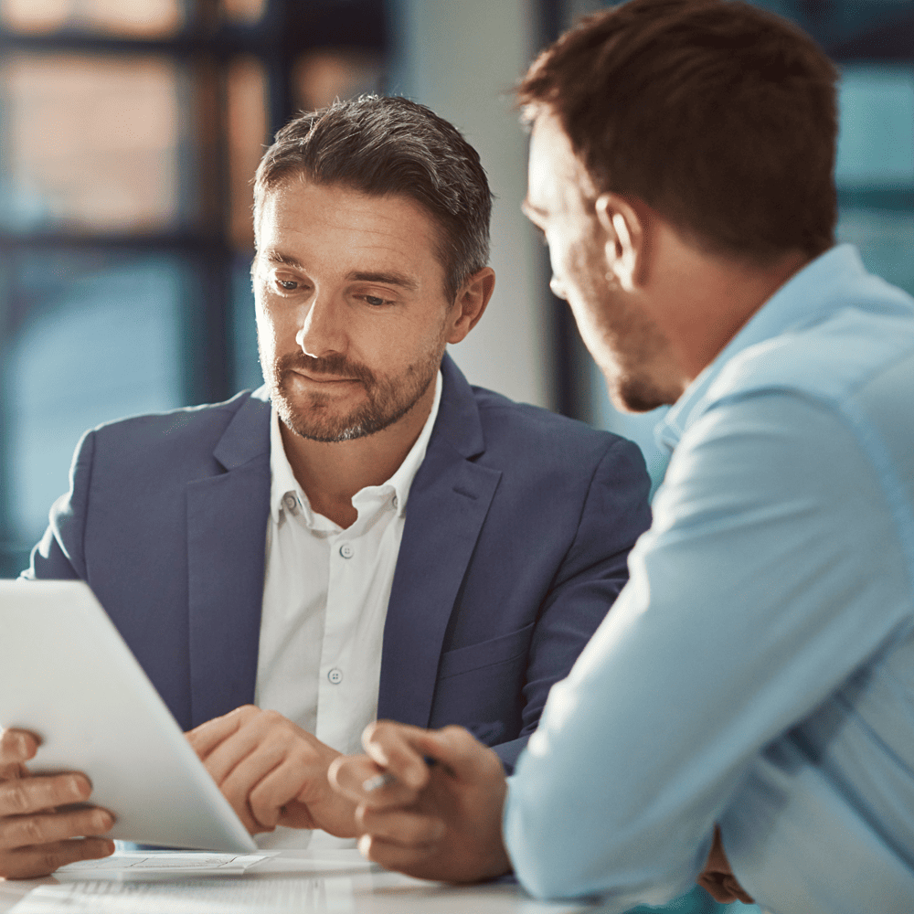 A TFA employee engages in a one-on-one conversation with a client, presenting a Private offer using a tablet