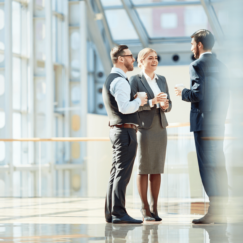 Business People talking in the hallway of In The Trenches Office