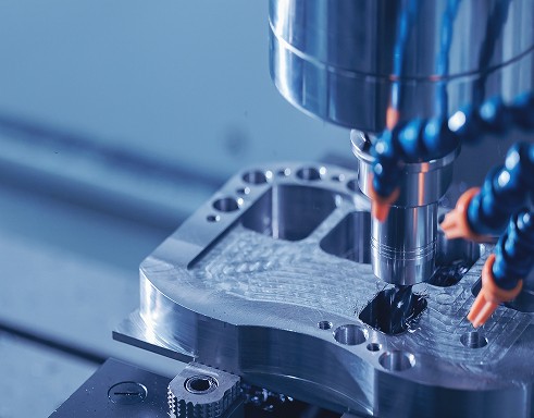 A machine processes a metal part in an industrial setting, representing equipment supported through asset finance solutions
