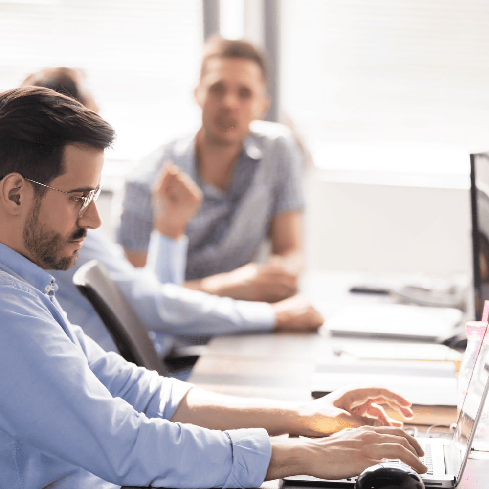 In the Trenches podcast - Business person working with a laptop