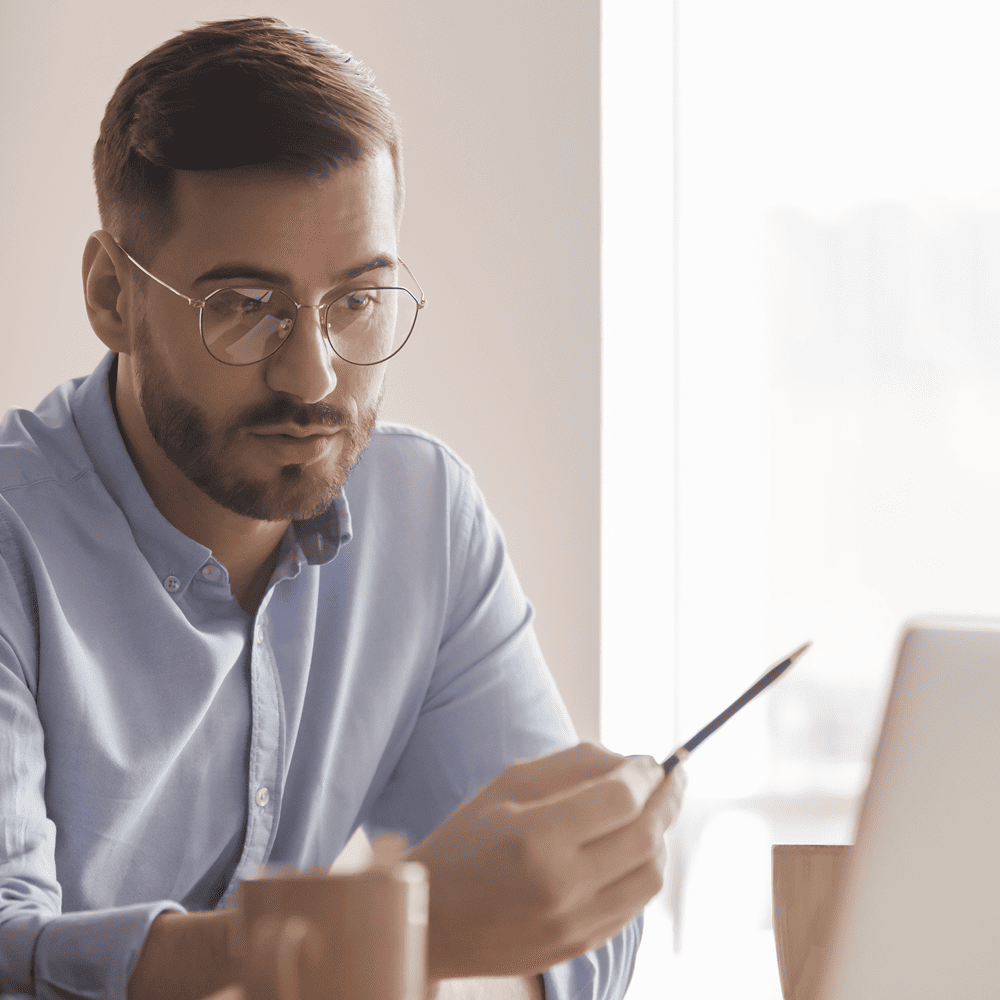 In the Trenches podcast - Businessman looking at laptop data